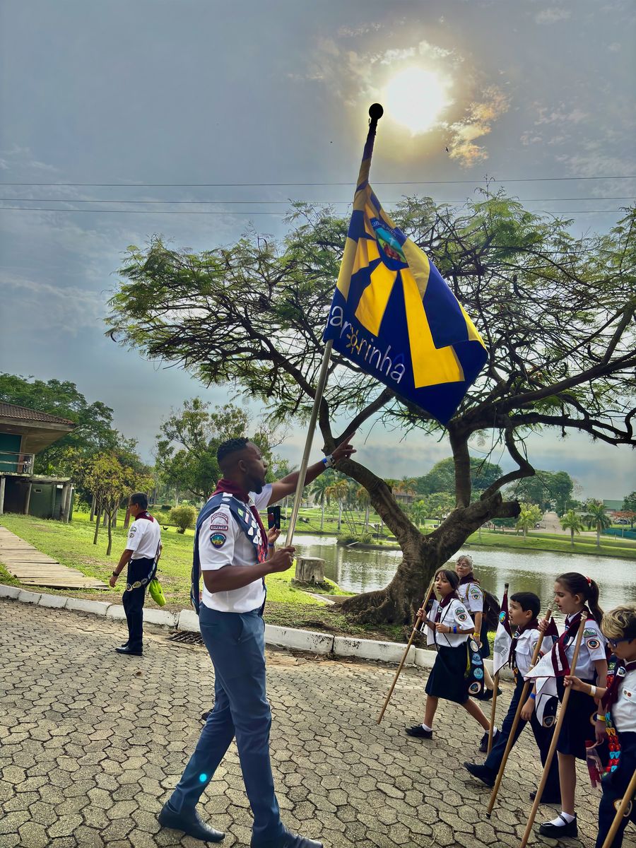 Diretor com a bandeira do Aurorinha e aventureiros com bandeirins